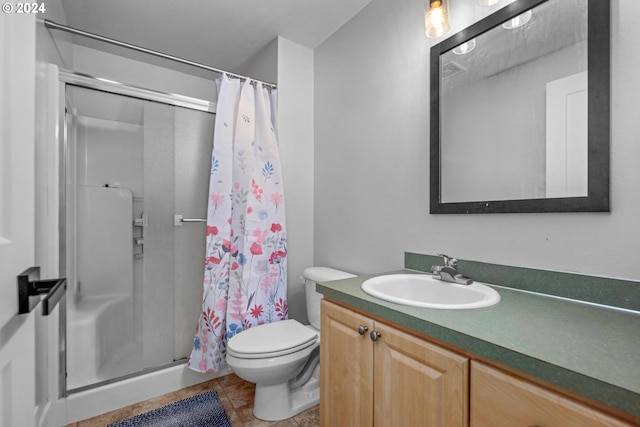 bathroom with tile patterned floors, vanity, toilet, and a shower with curtain