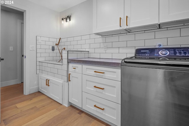 33020 S Dickey Prairie Rd, Molalla, OR 97038 - kitchen featuring washer / clothes dryer, light wood finished floors, white cabinetry, and decorative backsplash
