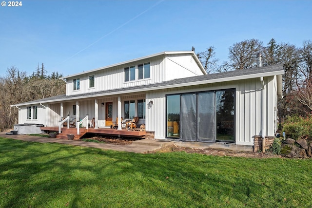 rear view of house featuring a yard