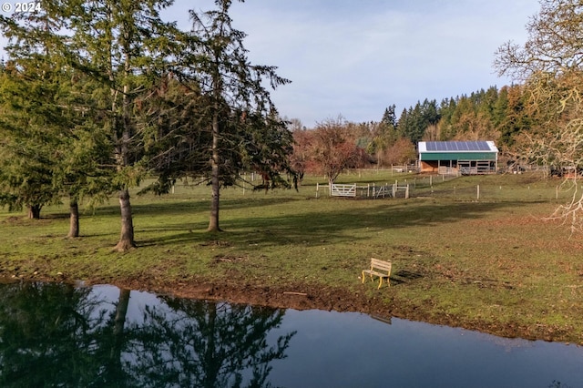 exterior space with a water view and a lawn