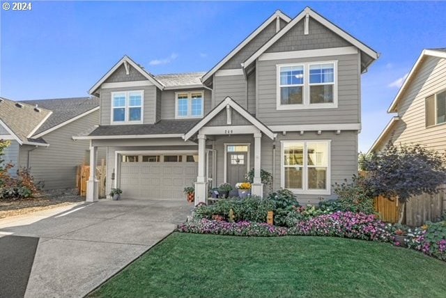 craftsman-style house featuring a front lawn and a garage