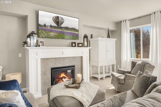 sitting room featuring a tiled fireplace