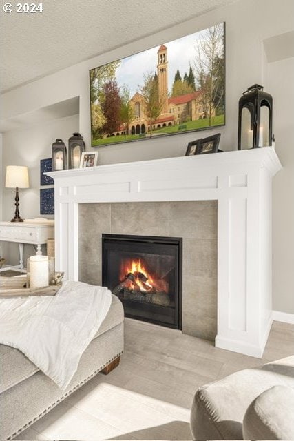 room details with a textured ceiling and a tiled fireplace