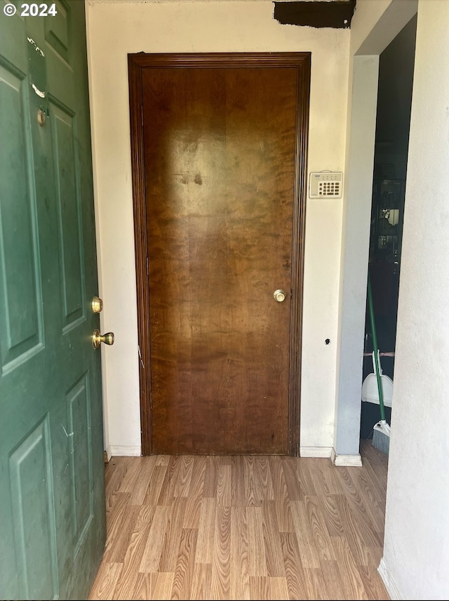 hallway with light hardwood / wood-style flooring