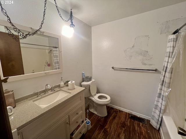 full bathroom with vanity, hardwood / wood-style floors, shower / bath combo, and toilet