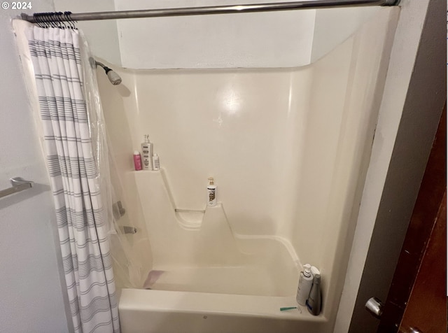 bathroom with shower / bath combo with shower curtain