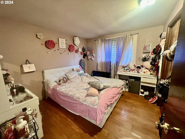 bedroom with hardwood / wood-style floors