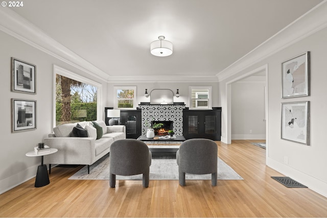 living room featuring crown molding and light wood-type flooring