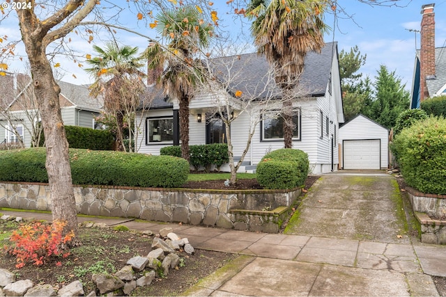 view of front of home with a garage and an outdoor structure