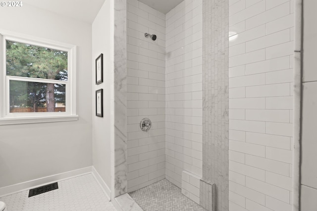 bathroom with tile patterned floors and a shower with shower door