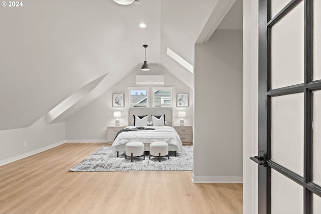 bedroom with light wood-type flooring, vaulted ceiling, and a wall mounted AC