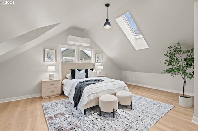 bedroom with a wall mounted air conditioner, vaulted ceiling, and light hardwood / wood-style flooring