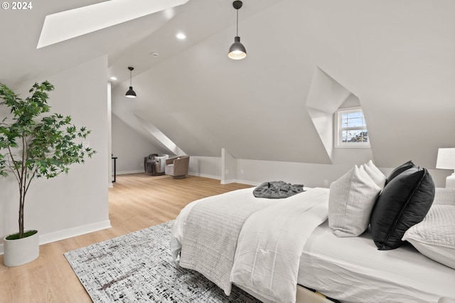 bedroom featuring wood-type flooring and lofted ceiling