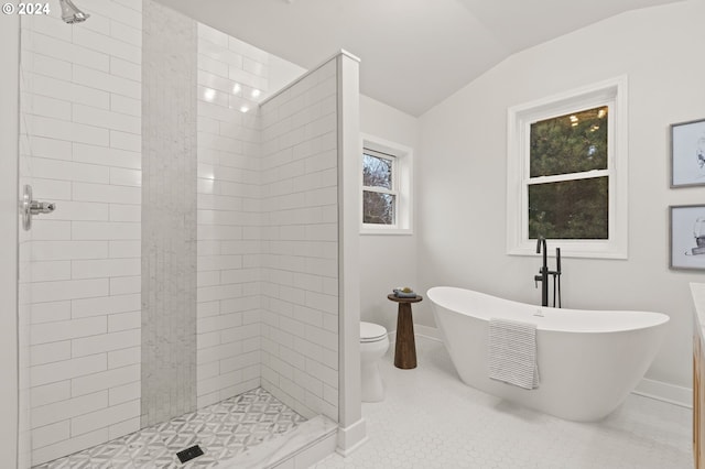 bathroom featuring plus walk in shower, tile patterned flooring, vaulted ceiling, and toilet