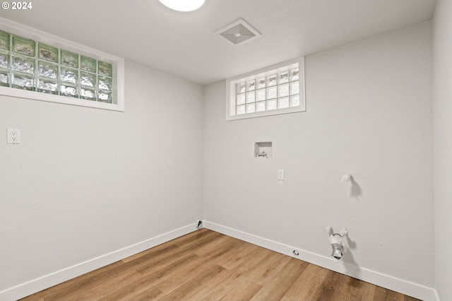 laundry area with wood-type flooring, hookup for a gas dryer, and hookup for a washing machine