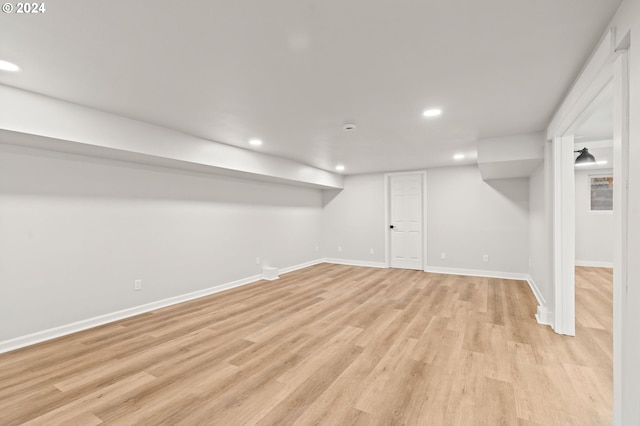 basement with light hardwood / wood-style floors