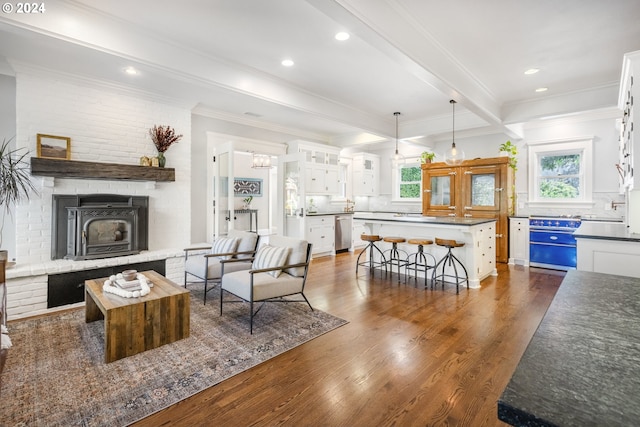 living area featuring crown molding, dark wood-style flooring, plenty of natural light, and beam ceiling