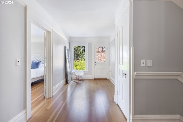 entryway featuring baseboards and wood finished floors