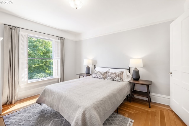 bedroom featuring baseboards and wood finished floors