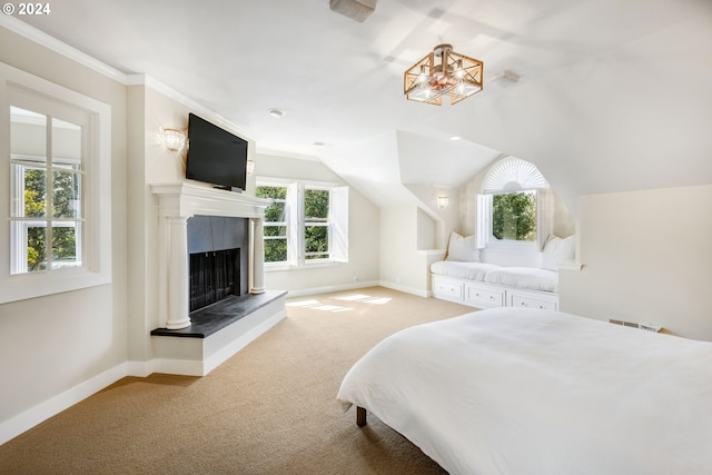 bedroom with baseboards, a fireplace with raised hearth, lofted ceiling, carpet, and crown molding