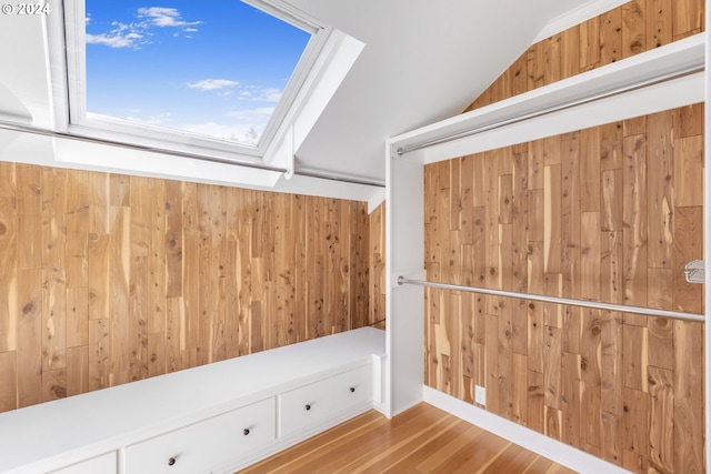 walk in closet with vaulted ceiling and wood finished floors