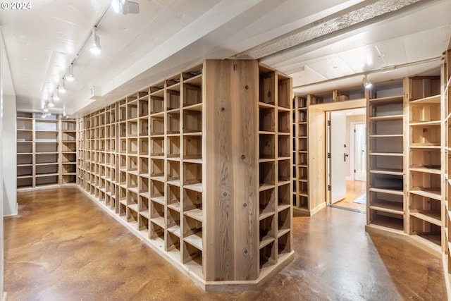 wine room with concrete floors and rail lighting