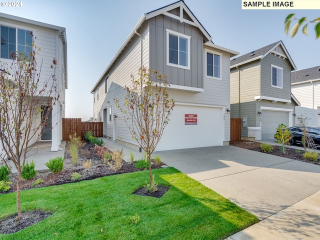 view of front of home with a front yard and a garage