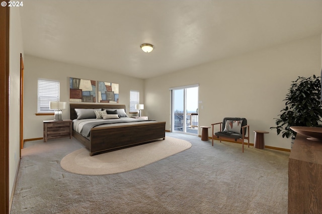 bedroom featuring access to exterior and light carpet