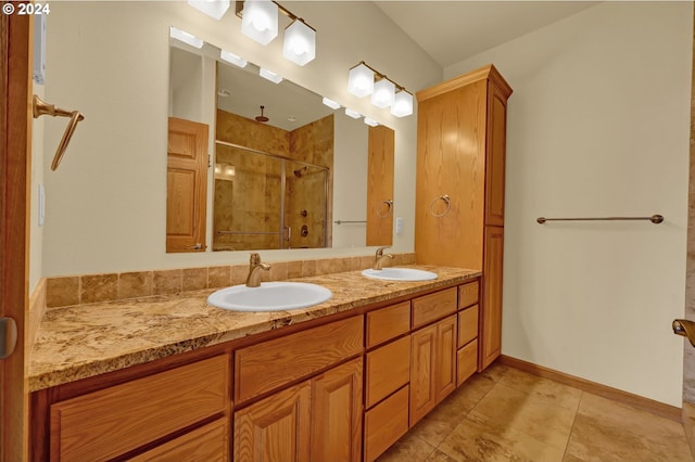 bathroom featuring tile patterned flooring, vanity, and walk in shower