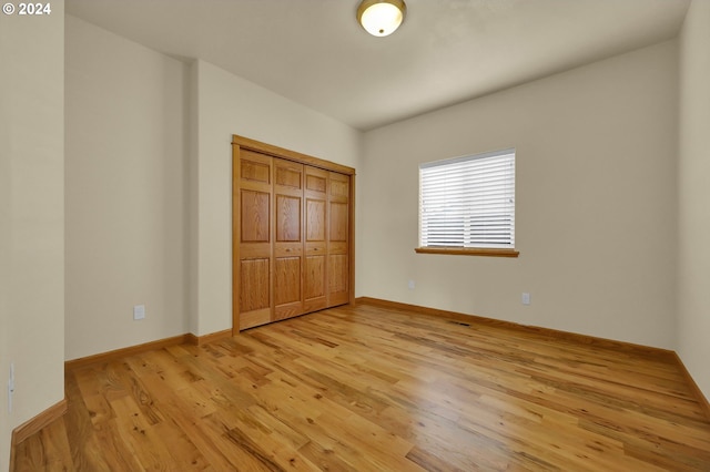 unfurnished bedroom featuring a closet and light hardwood / wood-style flooring