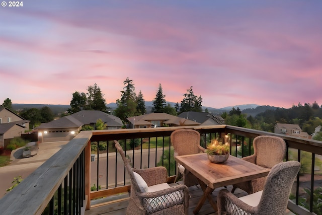 deck at dusk featuring a mountain view