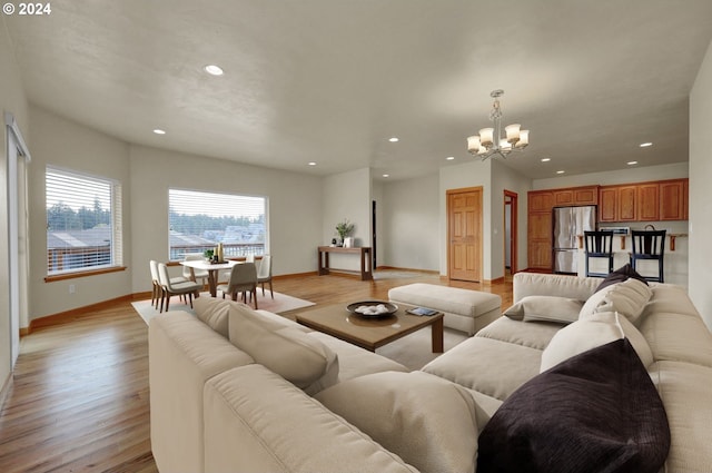 living room featuring light hardwood / wood-style floors and an inviting chandelier