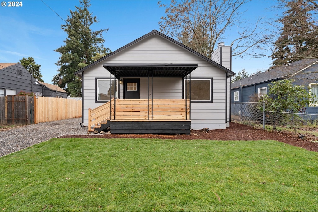 rear view of house with a lawn