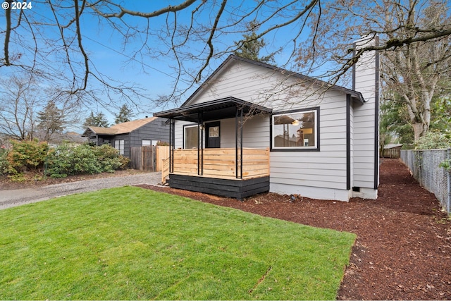 bungalow-style home featuring a front yard and covered porch