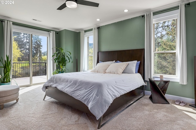 carpeted bedroom with multiple windows, access to exterior, and ceiling fan