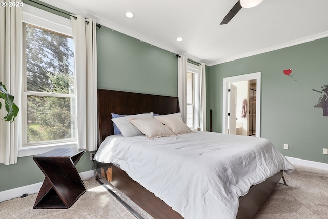 bedroom featuring ceiling fan, carpet, ornamental molding, and ensuite bathroom