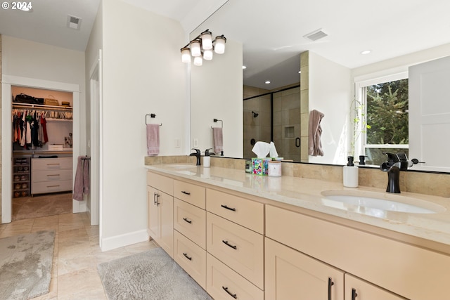 bathroom with tile patterned floors, double vanity, and an enclosed shower