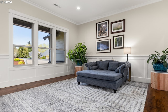 living area featuring crown molding and wood-type flooring