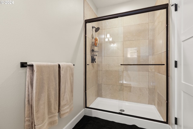 bathroom featuring a shower with shower door