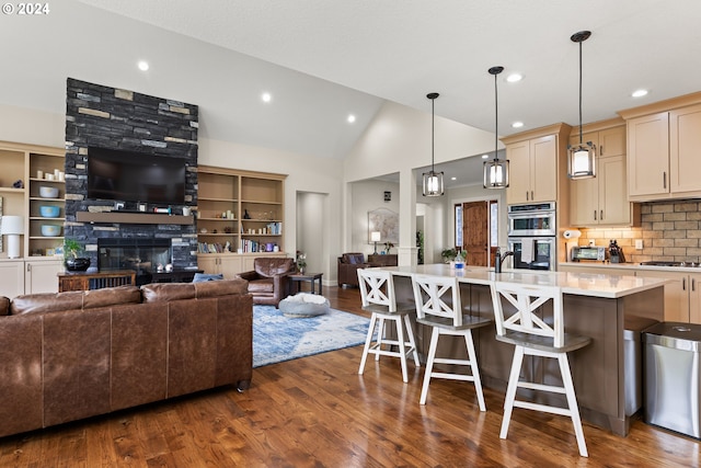 kitchen with dark hardwood / wood-style flooring, a fireplace, and a kitchen bar