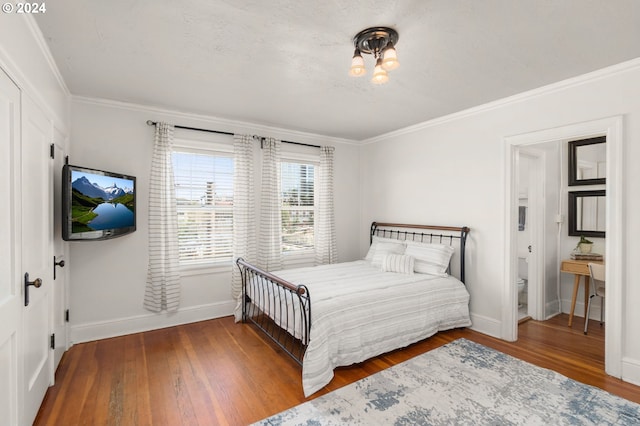 bedroom featuring wood-type flooring and ornamental molding