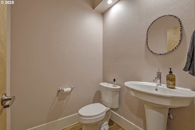 bathroom featuring toilet and sink