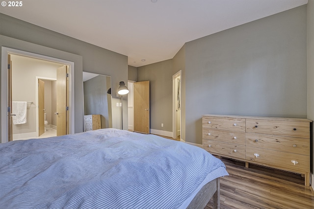 bedroom featuring ensuite bathroom and hardwood / wood-style flooring