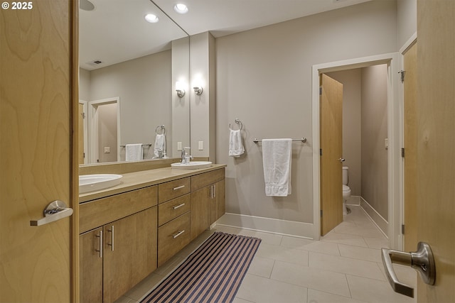 bathroom featuring tile patterned flooring, vanity, and toilet