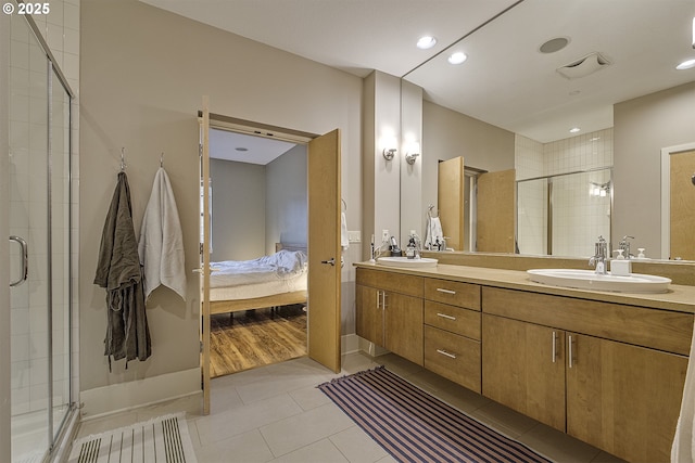 bathroom with vanity, tile patterned floors, and a shower with shower door