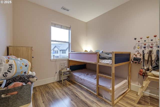 bedroom with hardwood / wood-style flooring