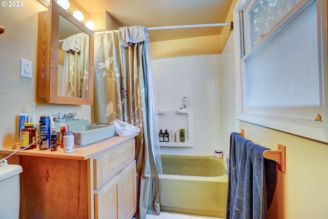 full bathroom with shower / tub combo, vanity, and toilet