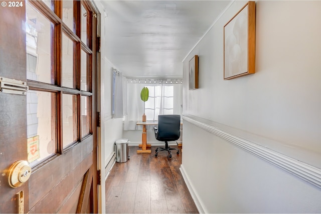 corridor with ornamental molding and dark wood-type flooring