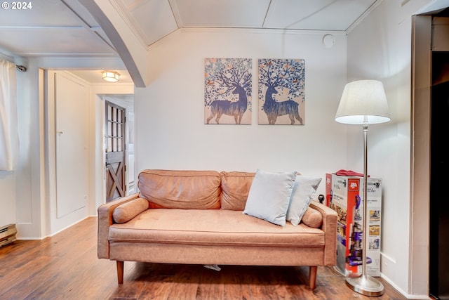 living room with ornamental molding and wood-type flooring