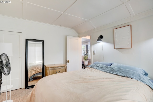 bedroom featuring light colored carpet and lofted ceiling